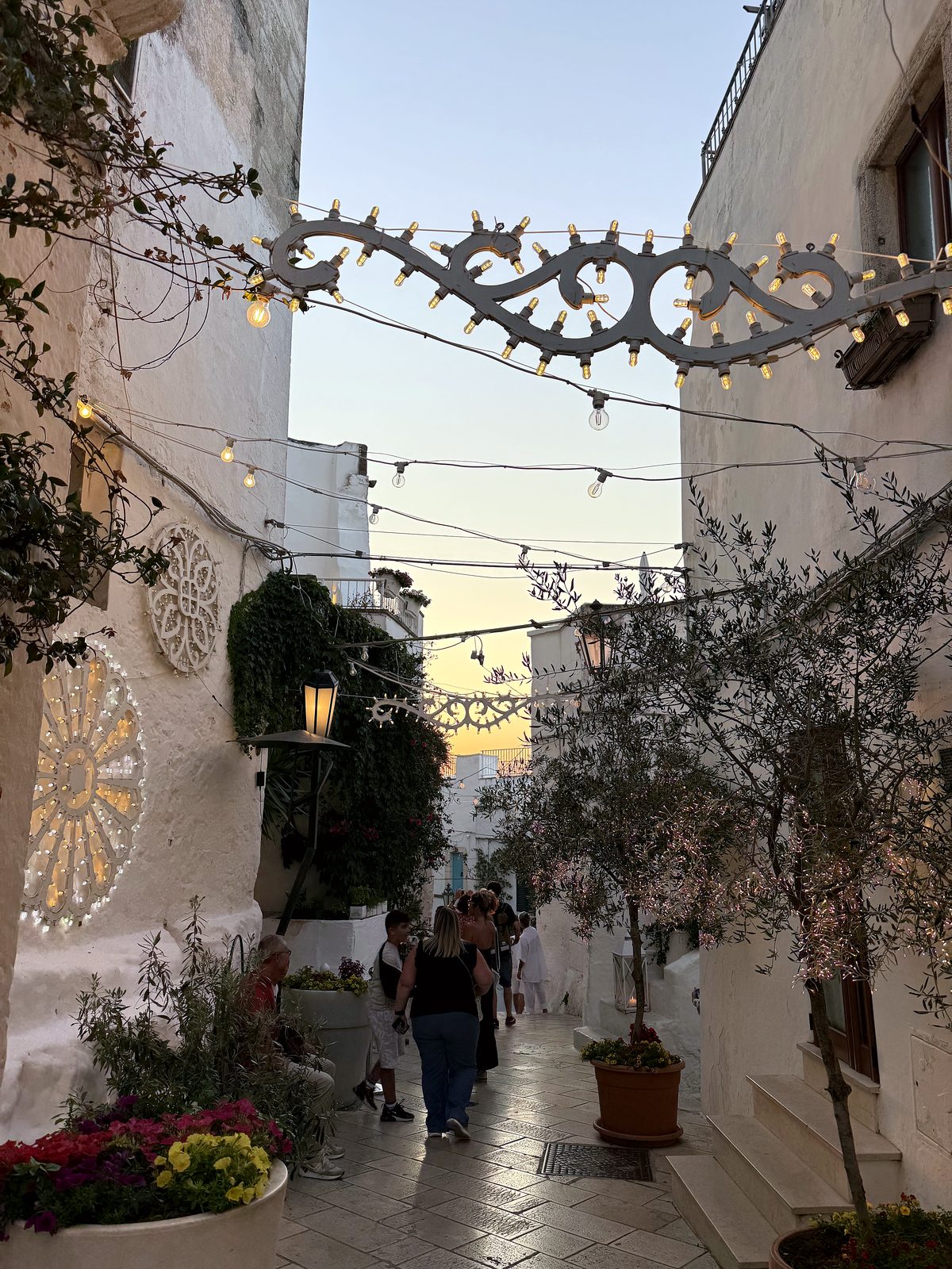 String lights over a whitewashed Ostuni alley