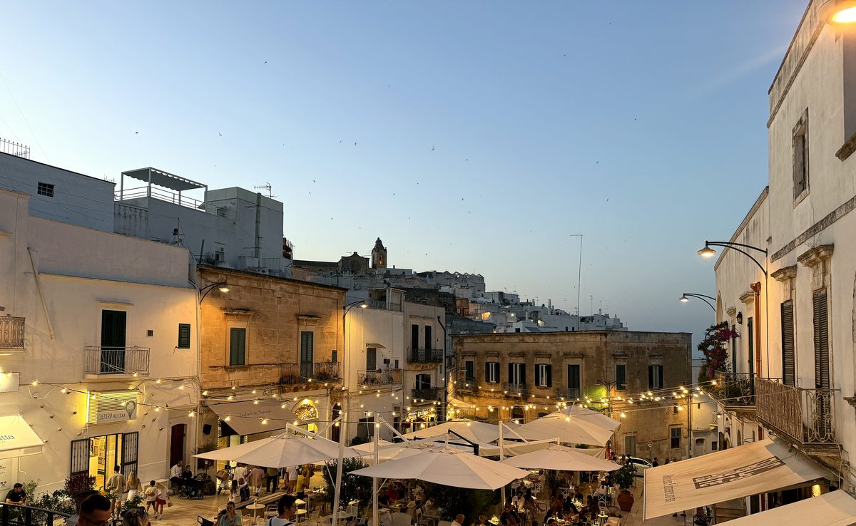 A whitewashed Ostuni square at dusk