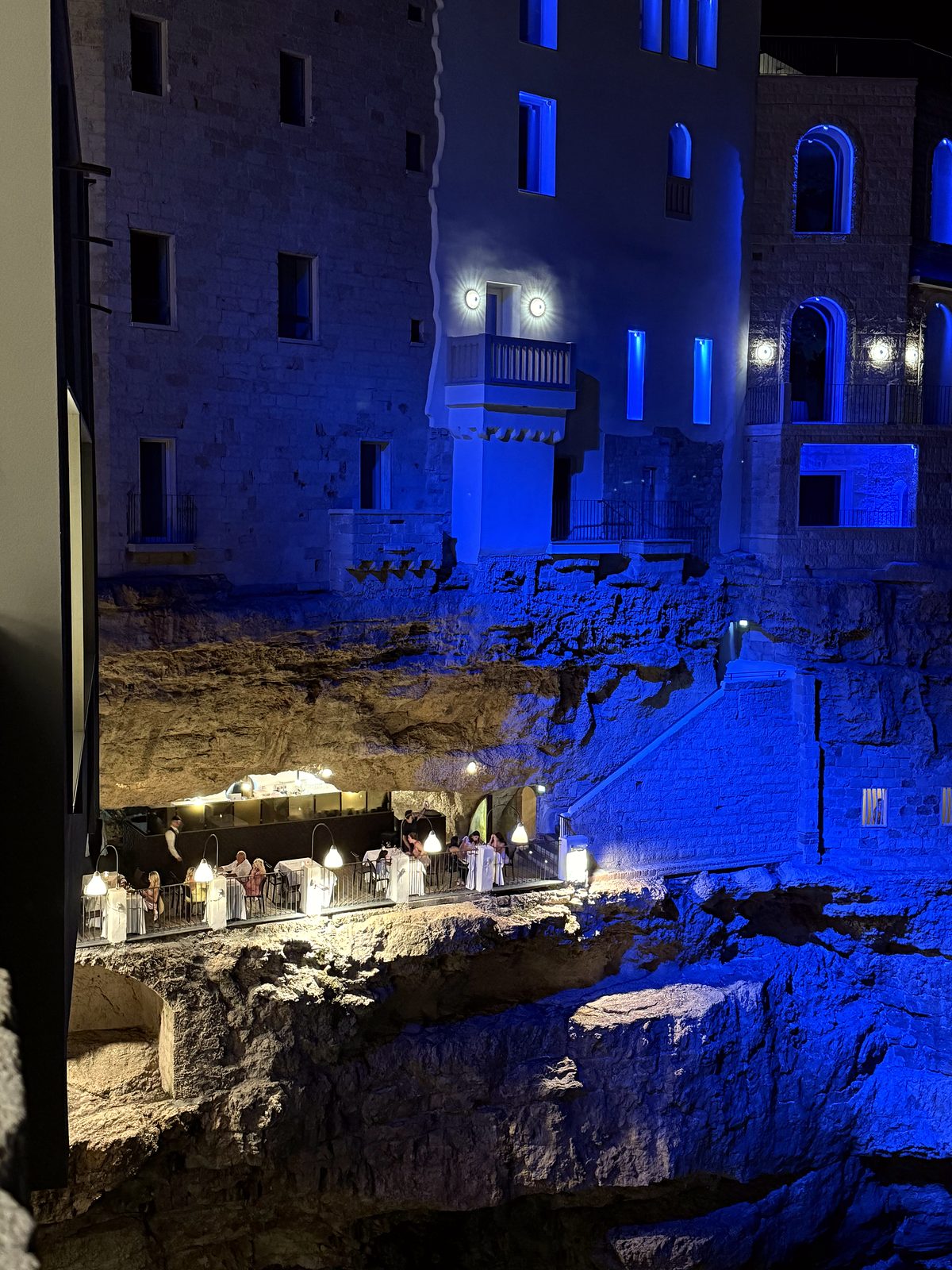The cliffside cave restaurant in Polignano lit at night