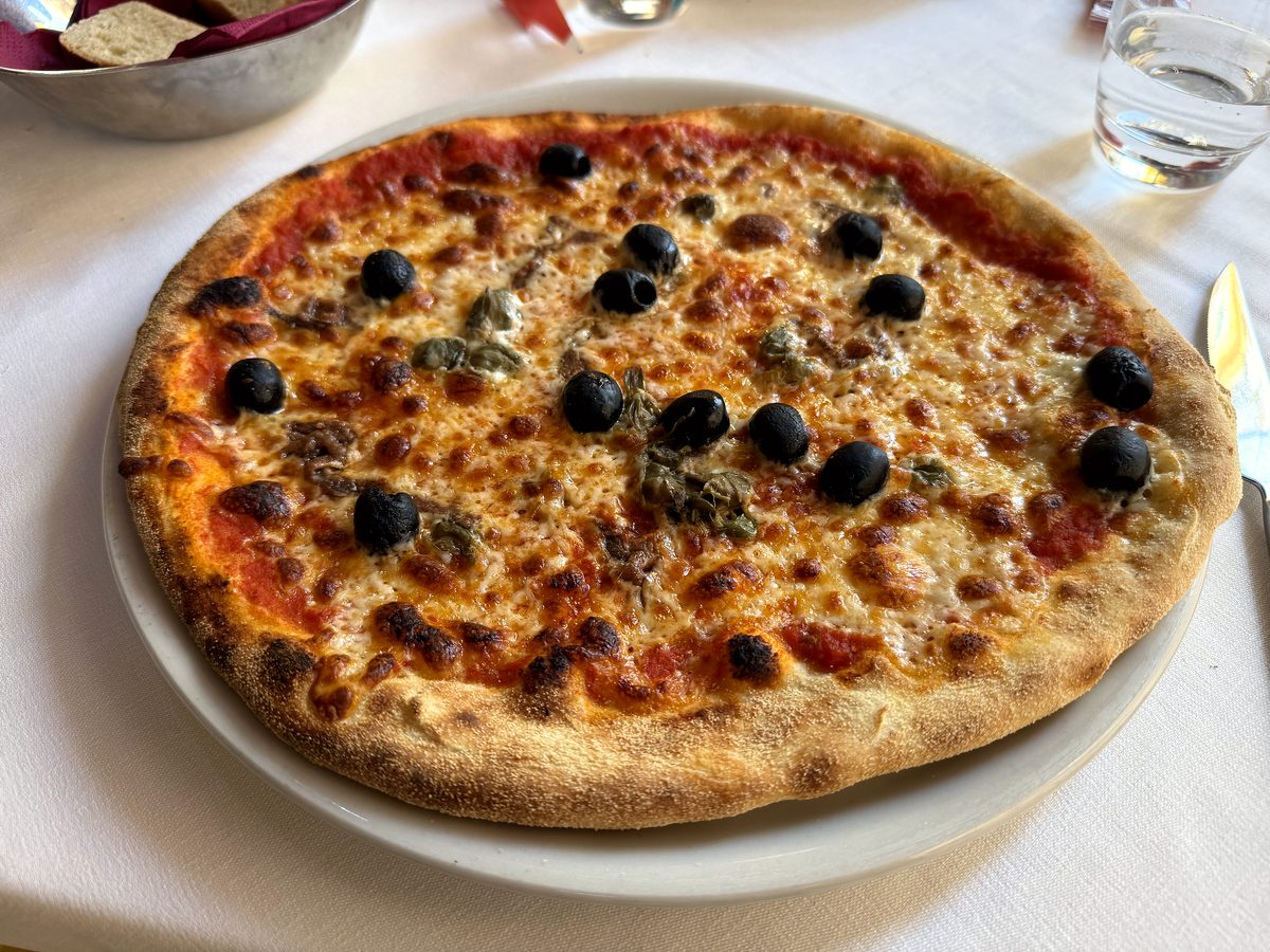 A pizza on a white tablecloth