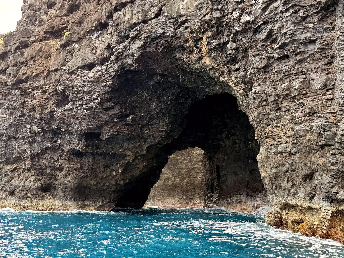 A sea arch along the Nā Pali coast from the water
