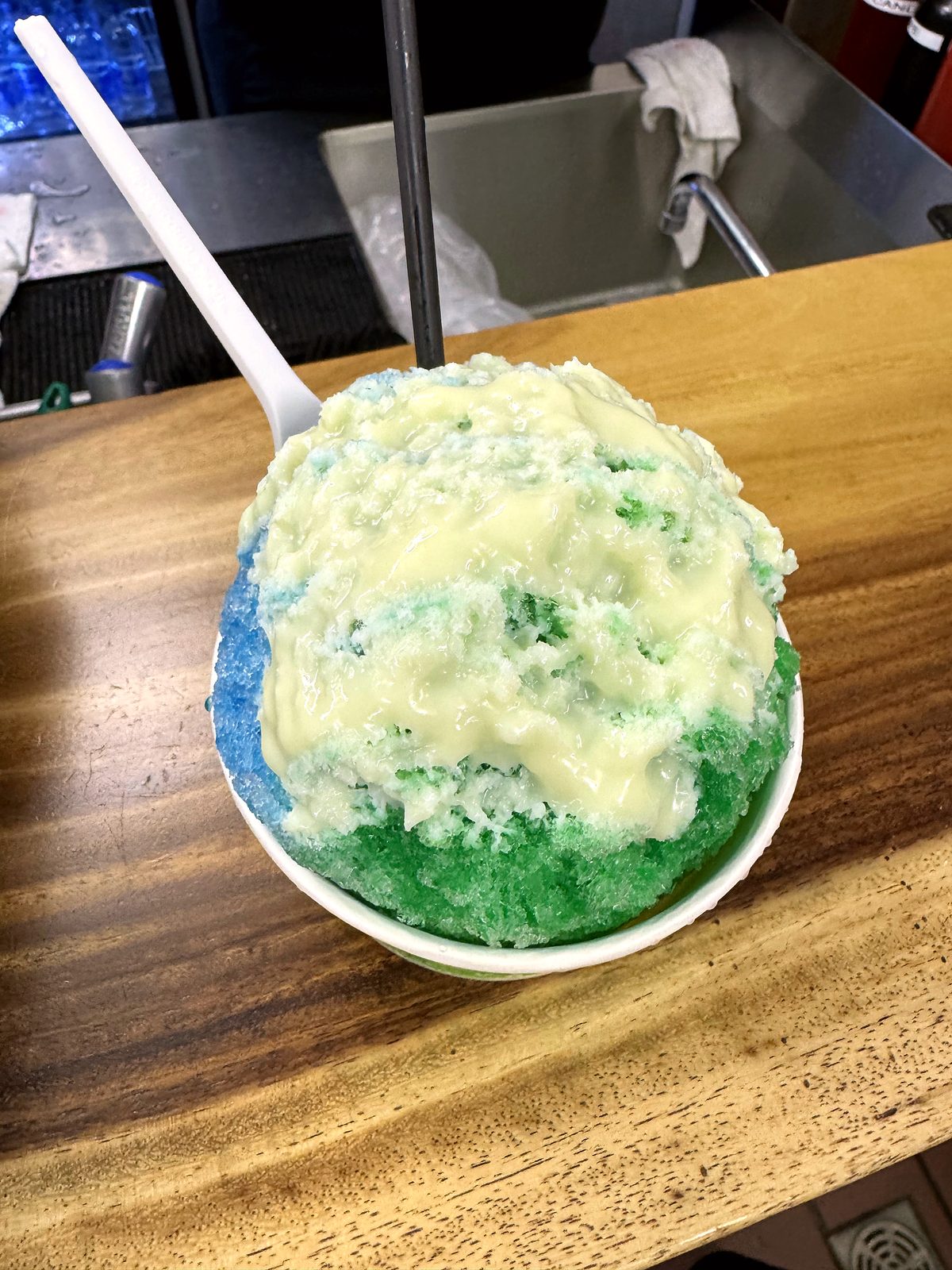 A shave ice finished with a snow cap of condensed milk
