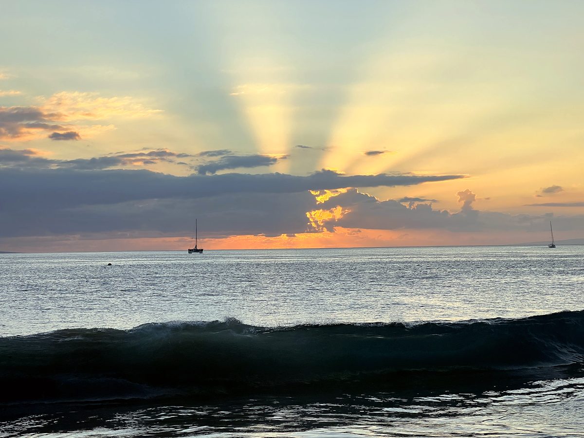 Sunbeams breaking over the water at dusk