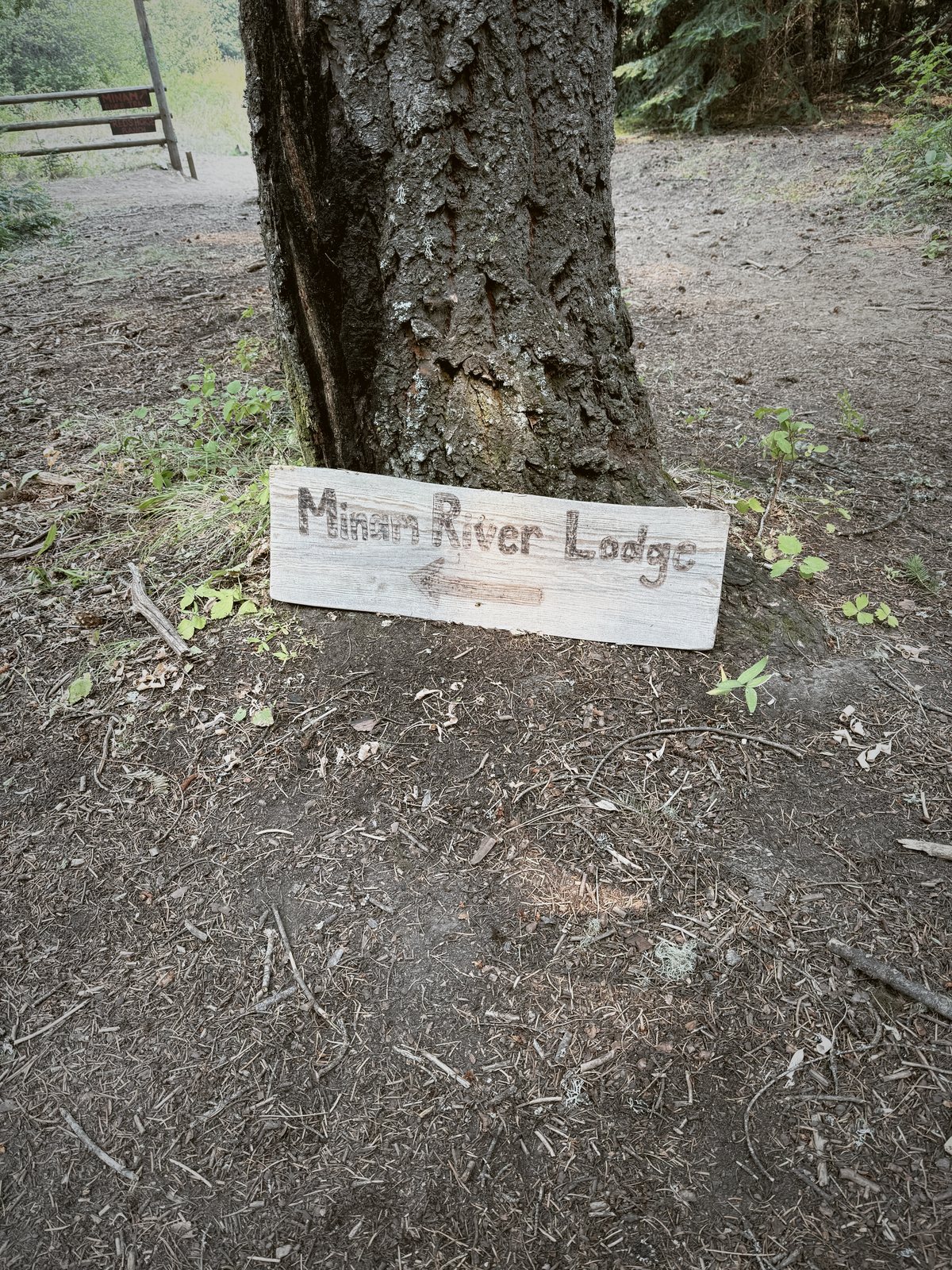 The Minam River Lodge sign on the trail in